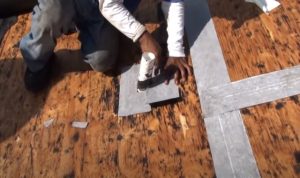 Roofing worker repairing the smoke chimney